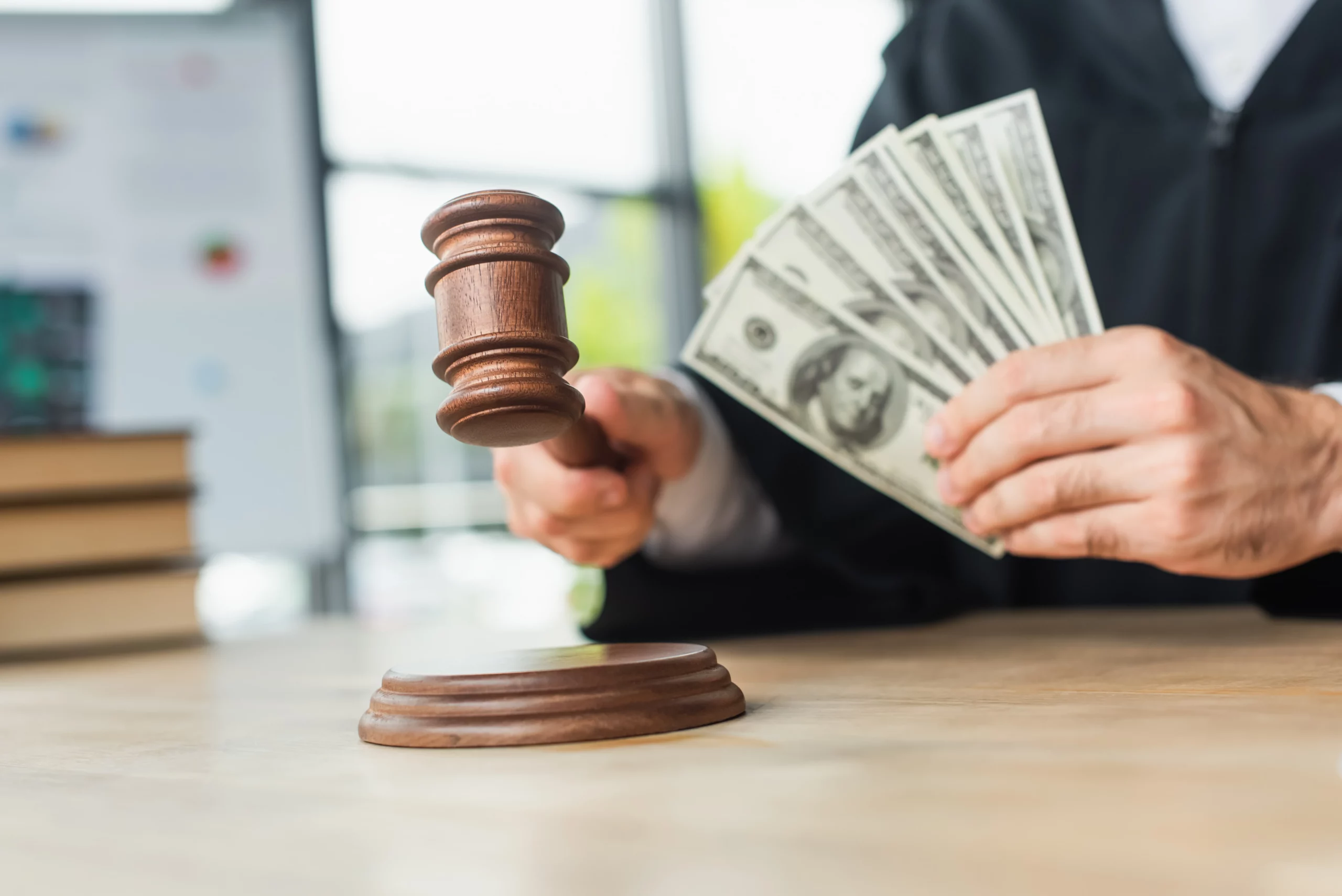 Judge holding a gavel with blurred money in the foreground, representing debt collection lawsuits and consumer rights in an LVNV Funding case in Missouri.