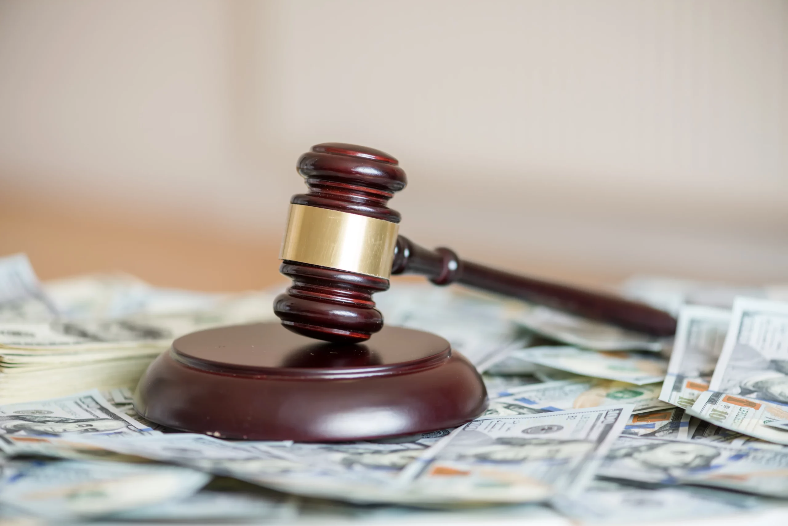 Judge’s gavel beside stacks of money representing a Midland Funding debt collection lawsuit and consumer debt defense in Missouri.
