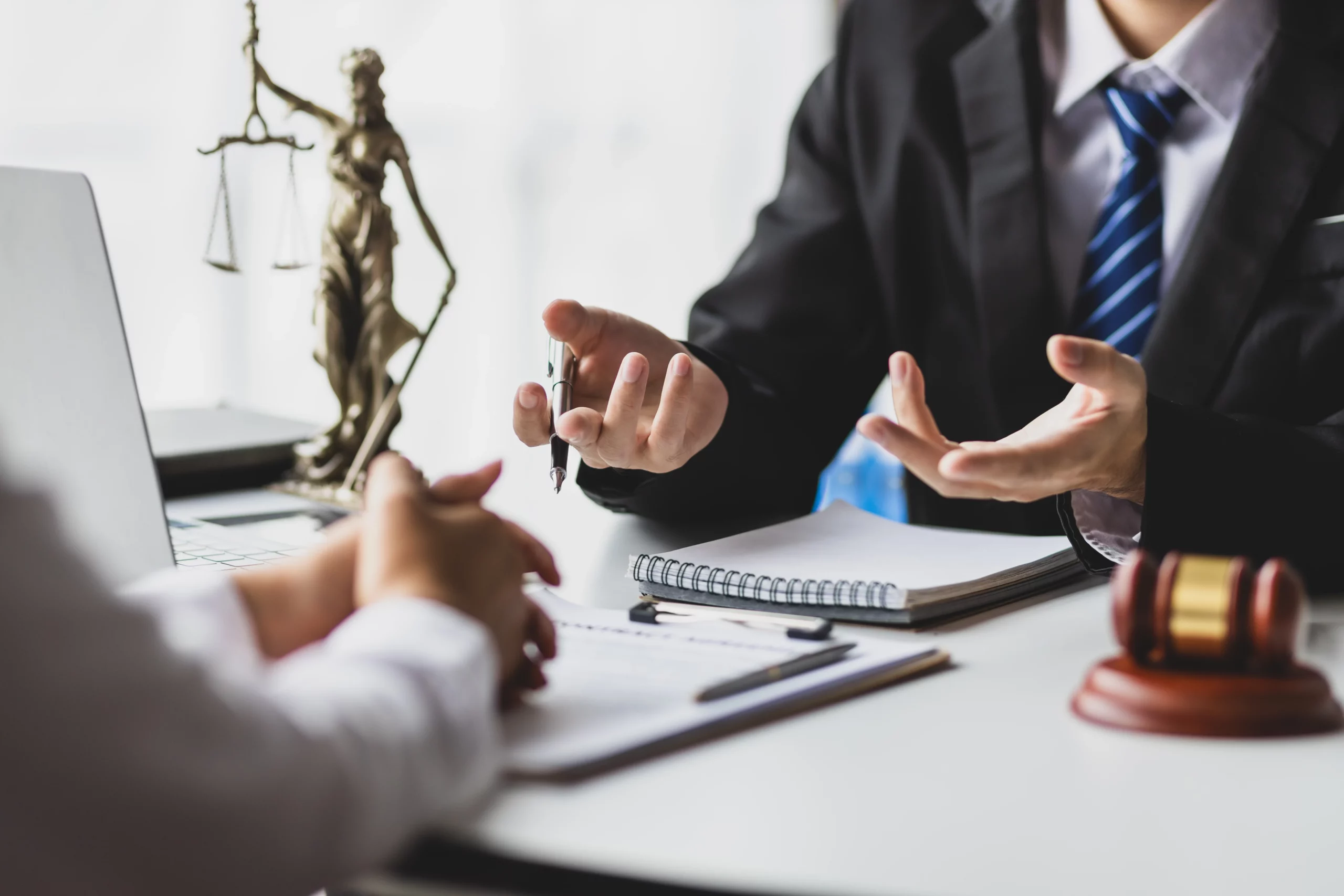 Attorney providing legal consultation to a client in a bright business office, illustrating professional settlement advice and legal guidance for Missouri debt lawsuit cases compared to AI chatbot assistance.